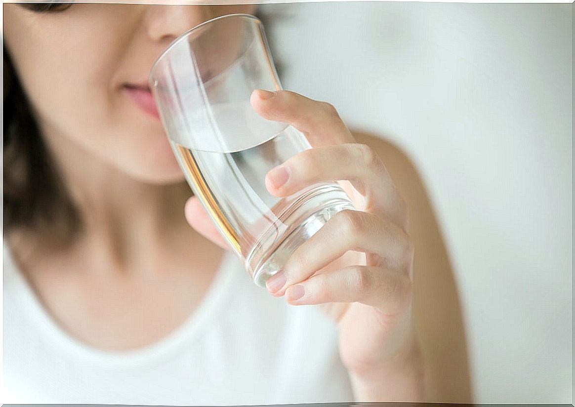 Woman drinks water from glass