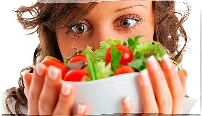 Woman eating well with a salad