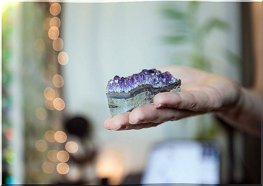 Hand holding an amethyst.